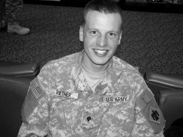 Luke Riether as a young soldier in his U.S. Army uniform, smiling