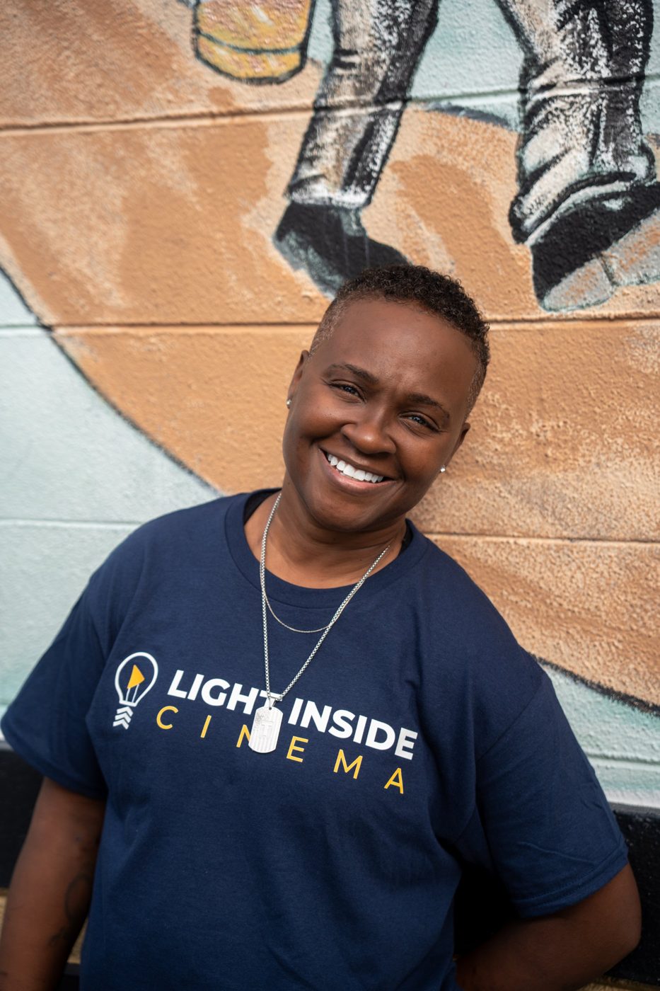 A Light Inside Cinema veteran smiling in the navy Light Inside Cinema shirt