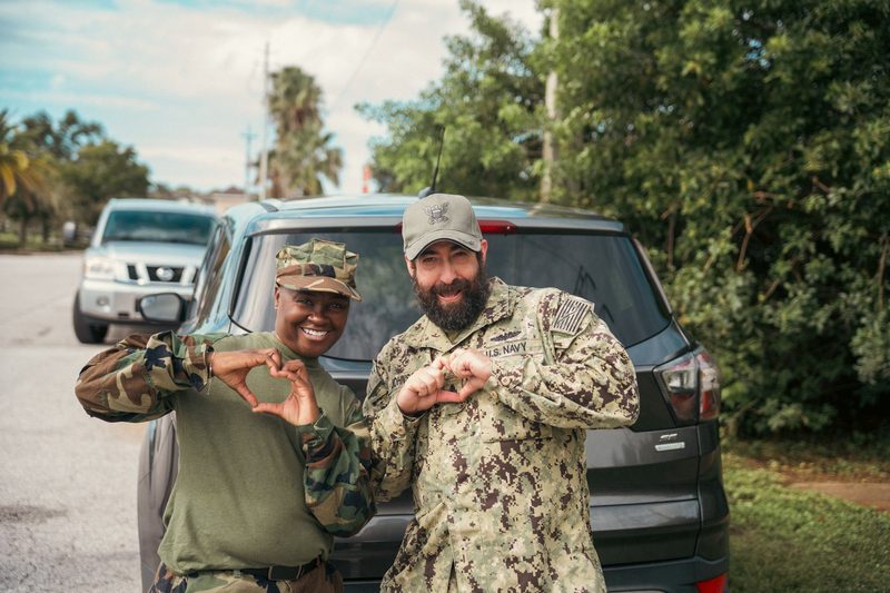 Two veterans laughing on set